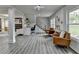 Bright living room with fireplace, modern flooring, ample natural light, and a staircase leading to the upper level at 226 Sandra Nw Dr, Lilburn, GA 30047