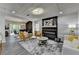 Spacious living area featuring a modern fireplace, stylish furnishings, and seamless flow to the dining room at 226 Sandra Nw Dr, Lilburn, GA 30047