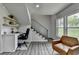 Stylish living area featuring a desk, chair, staircase, wood-look floors, and natural light from the window at 226 Sandra Nw Dr, Lilburn, GA 30047