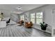 Bright living room with modern flooring, ample natural light, and a staircase leading to the upper level at 226 Sandra Nw Dr, Lilburn, GA 30047