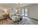 Serene primary bedroom features a decorative accent wall, natural light, and private balcony access at 226 Sandra Nw Dr, Lilburn, GA 30047