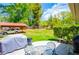 Large backyard featuring a covered carport, green grass, and outdoor patio set at 3224 Laura Way, Winston, GA 30187