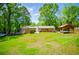 Large backyard with a carport, well-maintained lawn, and brick home exterior at 3224 Laura Way, Winston, GA 30187