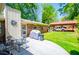 Inviting backyard with brick home, carport, patio with furniture, and manicured lawn at 3224 Laura Way, Winston, GA 30187