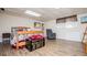 Open basement space featuring plank flooring, a comfortable bed, and a cozy reading chair at 3224 Laura Way, Winston, GA 30187
