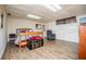 Open basement space featuring plank flooring, a comfortable bed, and a cozy reading chair at 3224 Laura Way, Winston, GA 30187