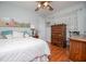 Inviting bedroom boasts hardwood floors, a cozy bed with throw pillows, and charming wooden furniture at 3224 Laura Way, Winston, GA 30187