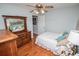 Cozy bedroom with hardwood floors, a comfy bed, and a large wooden dresser for ample storage at 3224 Laura Way, Winston, GA 30187
