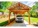 Carport with a rustic-style frame featuring a star decoration and a modern SUV parked underneath at 3224 Laura Way, Winston, GA 30187