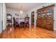 Traditional dining room featuring hardwood floors, chandelier, and wooden furniture with china cabinet at 3224 Laura Way, Winston, GA 30187