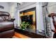 Elegant fireplace with marble surround, gold accents, and wooden flooring in the living room at 3224 Laura Way, Winston, GA 30187