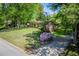 Brick ranch-style home with mature trees, a well-manicured lawn, and front yard landscaping at 3224 Laura Way, Winston, GA 30187