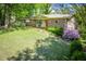 Ranch-style home with brick exterior, covered porch, and well-maintained lawn with mature trees at 3224 Laura Way, Winston, GA 30187