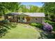 Charming brick home featuring a cozy front porch, mature trees, and a well-manicured lawn at 3224 Laura Way, Winston, GA 30187