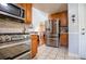 Bright kitchen with oak cabinets, stainless steel appliances, and a tiled floor at 3224 Laura Way, Winston, GA 30187
