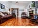 Bright living room featuring hardwood floors, fireplace, and leather seating open to kitchen at 3224 Laura Way, Winston, GA 30187