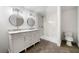 Elegant bathroom with double sinks, modern lighting, and a walk-in shower at 3460 Old Fairburn Rd, South Fulton, GA 30349