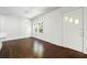 Bright living room with hardwood floors, light fixture and a white front door with decorative windows at 3460 Old Fairburn Rd, South Fulton, GA 30349