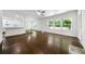 Bright living room features hardwood floors, large windows, and an open layout to the kitchen at 3460 Old Fairburn Rd, South Fulton, GA 30349