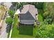 Aerial perspective showcasing a meticulously landscaped yard, established trees, and a well-kept home at 6414 Blue Water Dr, Buford, GA 30518