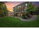 Spacious backyard featuring a lush lawn, stone patio, and a two-story screened porch at 6414 Blue Water Dr, Buford, GA 30518