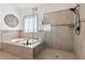 Elegant bathroom showcasing a glass enclosed walk-in shower, soaker tub, and decorative tile at 6414 Blue Water Dr, Buford, GA 30518