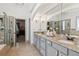 Bright bathroom features a dual sink vanity with granite countertops, and walk-in shower at 6414 Blue Water Dr, Buford, GA 30518