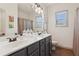 Double vanity bathroom with a large mirror, dual sinks, and plenty of counter space at 6414 Blue Water Dr, Buford, GA 30518