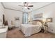 Cozy bedroom featuring a ceiling fan, a bed with plush bedding, and warm natural light at 6414 Blue Water Dr, Buford, GA 30518