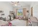 Charming bedroom with pink accents, a ceiling fan, and ample natural light, ideal for a room at 6414 Blue Water Dr, Buford, GA 30518
