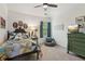Cozy bedroom featuring a ceiling fan, a comfortable bed, and a green dresser for ample storage at 6414 Blue Water Dr, Buford, GA 30518