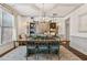 Formal dining room featuring stylish chairs, and ample lighting, set atop an area rug at 6414 Blue Water Dr, Buford, GA 30518