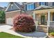 Attractive brick home featuring a well-manicured lawn and charming front porch with detailed trim at 6414 Blue Water Dr, Buford, GA 30518
