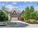 Charming two-story home with landscaped yard and a two-car garage, surrounded by trees at 6414 Blue Water Dr, Buford, GA 30518