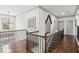 Bright upstairs hallway boasting hardwood floors, black metal railings, and modern trim at 6414 Blue Water Dr, Buford, GA 30518