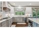 Modern eat-in kitchen with stainless appliances, white cabinetry, and tile backsplash at 6414 Blue Water Dr, Buford, GA 30518
