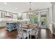 Open concept eat-in kitchen with stainless appliances, island, and modern chandelier at 6414 Blue Water Dr, Buford, GA 30518