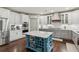 Modern kitchen with island, stainless appliances, tile backsplash and stylish cabinetry at 6414 Blue Water Dr, Buford, GA 30518