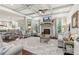 Open concept living room with coffered ceiling, fireplace, and view of eat-in kitchen at 6414 Blue Water Dr, Buford, GA 30518