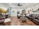 Spacious living room with wood flooring, leather seating, and ample room for entertaining at 6414 Blue Water Dr, Buford, GA 30518