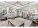 Spacious living room with open staircase, view of kitchen, and hardwood floors at 6414 Blue Water Dr, Buford, GA 30518