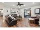 Comfortable living room with leather seating, wood floors, and seamless flow to the exercise room at 6414 Blue Water Dr, Buford, GA 30518