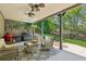 Enjoy outdoor living on this covered patio with comfortable seating and a built-in grilling area at 6414 Blue Water Dr, Buford, GA 30518