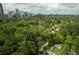 Aerial view of the property featuring mature tree cover and proximity to the city skyline at 3840 Wieuca Ne Ter, Atlanta, GA 30342