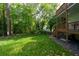 Lush green backyard with mature trees and a charming deck with stairs at 3840 Wieuca Ne Ter, Atlanta, GA 30342