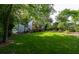 Large, well-maintained backyard with mature trees, grass lawn, back deck, and stairs at 3840 Wieuca Ne Ter, Atlanta, GA 30342