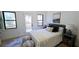 Cozy bedroom featuring a walk-out deck, neutral decor, and ample natural light through black trimmed windows at 3840 Wieuca Ne Ter, Atlanta, GA 30342