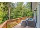 Outdoor deck with wood flooring and comfortable seating surrounded by lush greenery and exterior siding at 3840 Wieuca Ne Ter, Atlanta, GA 30342