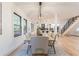 Dining area with a modern light fixture, view to the kitchen and stairs, and light hardwood floors at 3840 Wieuca Ne Ter, Atlanta, GA 30342