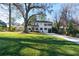 Beautiful two-story home with a lush green lawn and mature trees at 3840 Wieuca Ne Ter, Atlanta, GA 30342